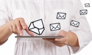 business woman using tablet computer and email icons
